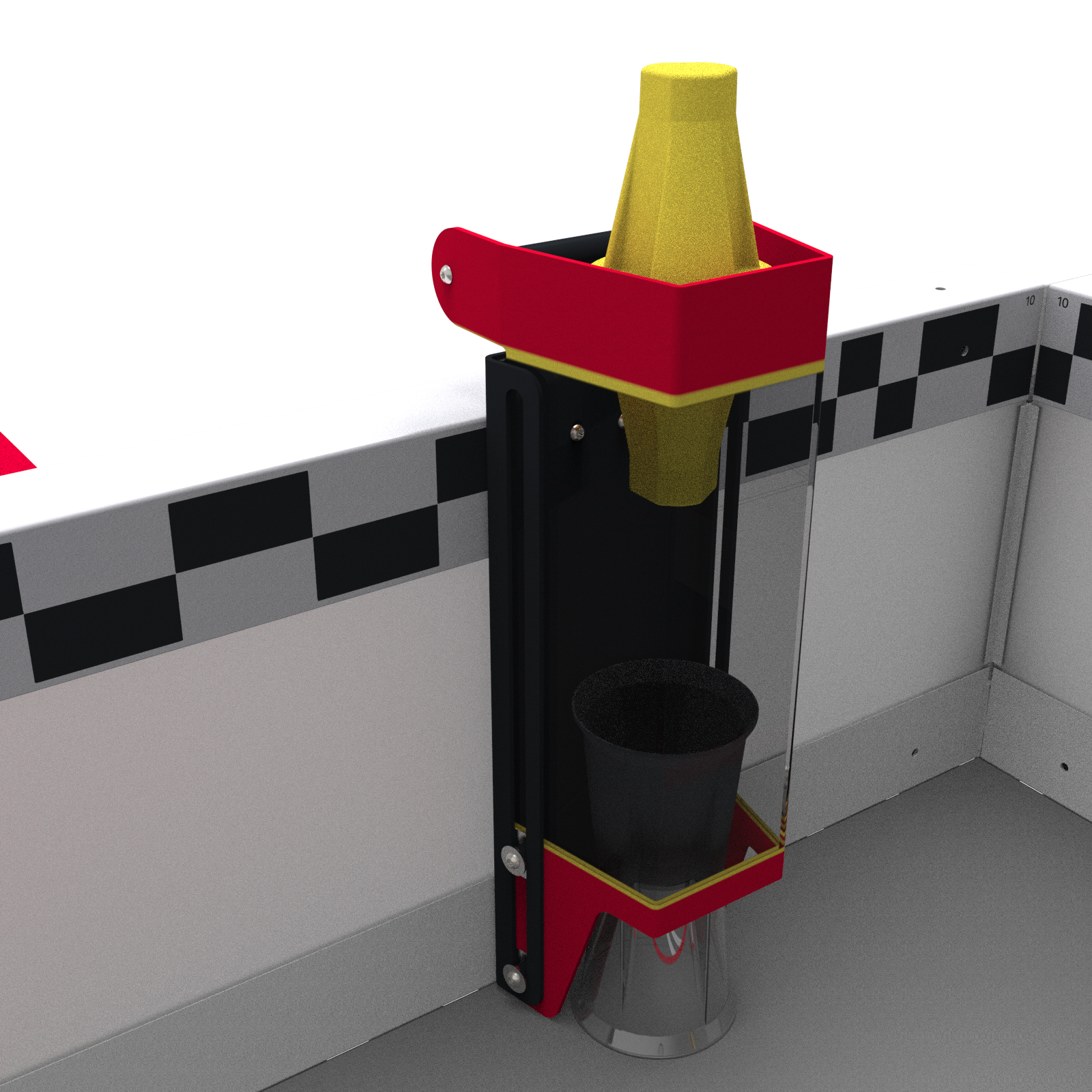 A close up of the loader with a yellow pin inserted in the top of the loader with a cup sitting on the field at the bottom of the loader.