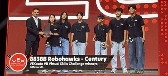 Seven students accept an award on stage at the VEX Robotics World Championship. A caption reads: 8838B Robohawks – Century, VEXcode VR Virtual Skills Challenge winners, California, USA.