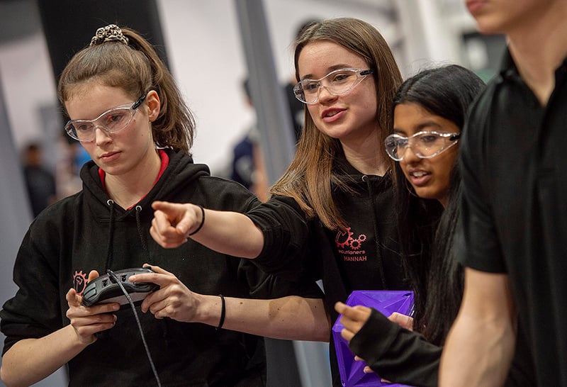 Students pointing in VEX competition