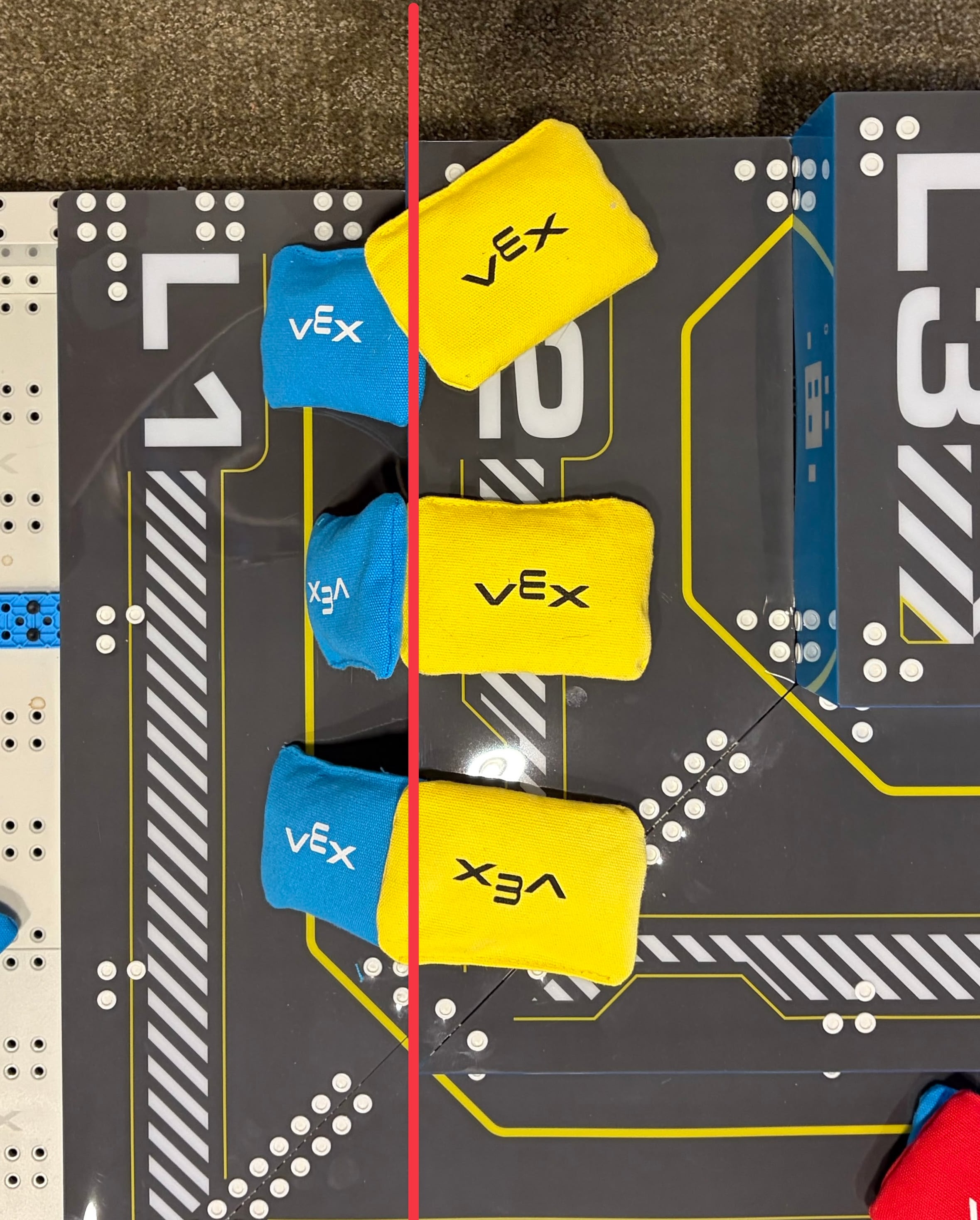 Top down view of a pyramid goal. Vertically three pairs of bean bags can be seen. All pairs show a blue bean bag to the left and the yellow to the right. A red line comes down the image along the edge of the goal that divides L 2 and L 3. The bean bags are placed as described in the text.