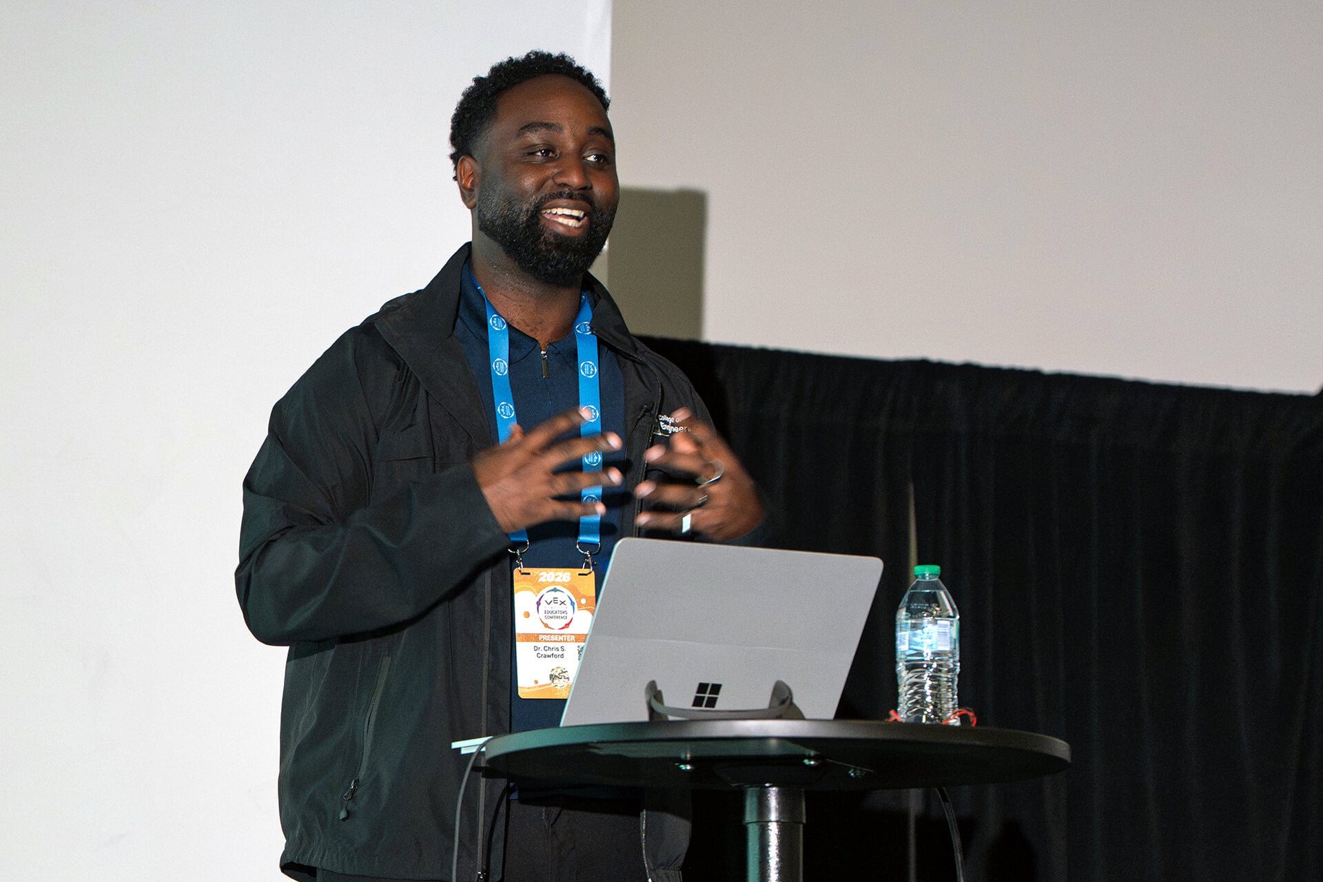 A presenter speaking to educators during a conference session.