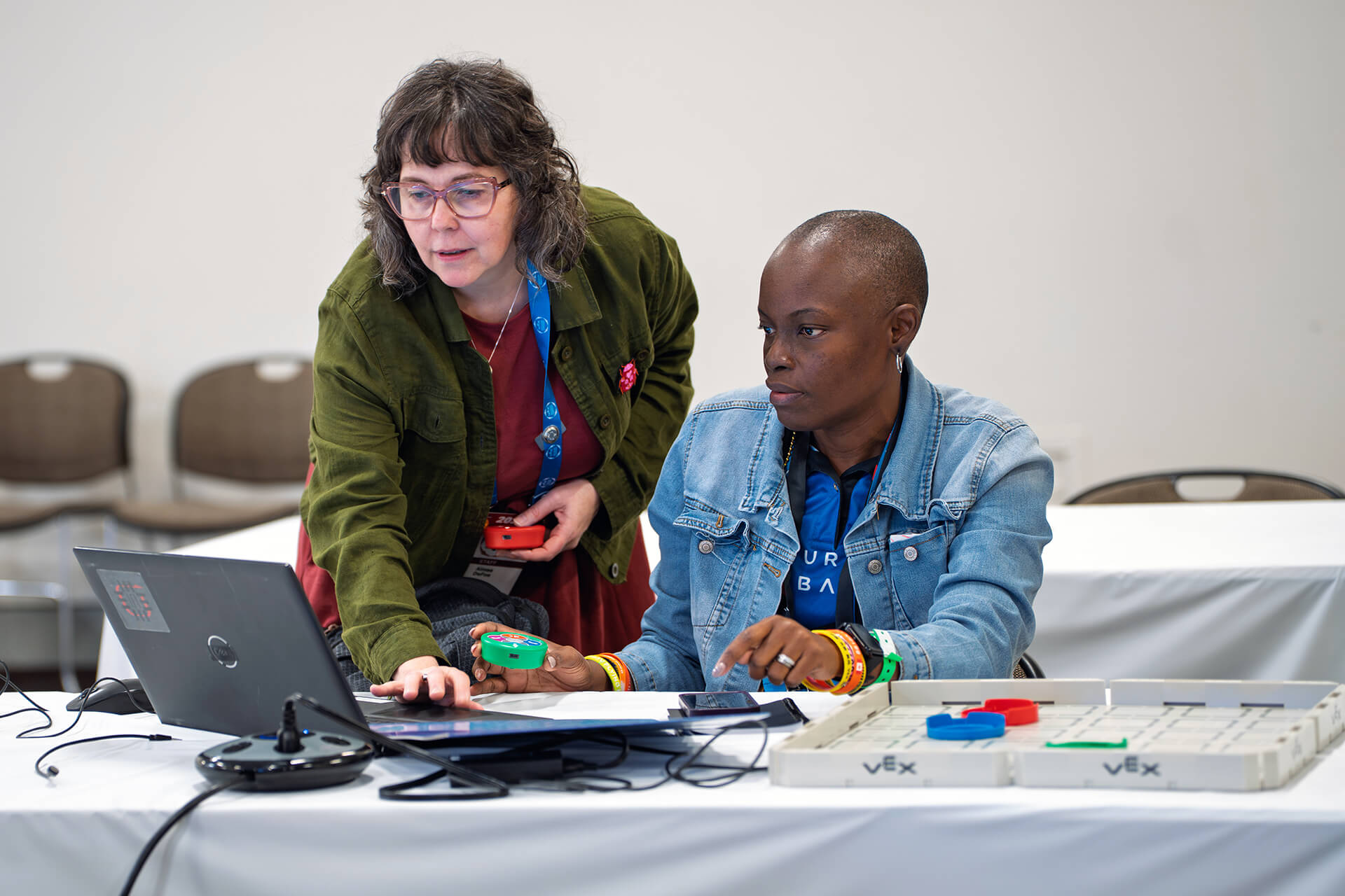 Educators collaborating with robotics materials during a hands-on workshop.