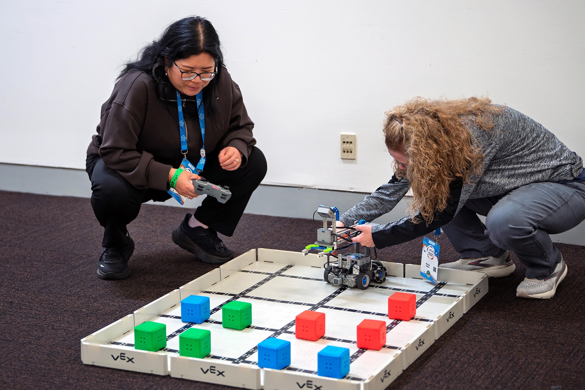 A VEX workshop facilitator helping educators during an activity.